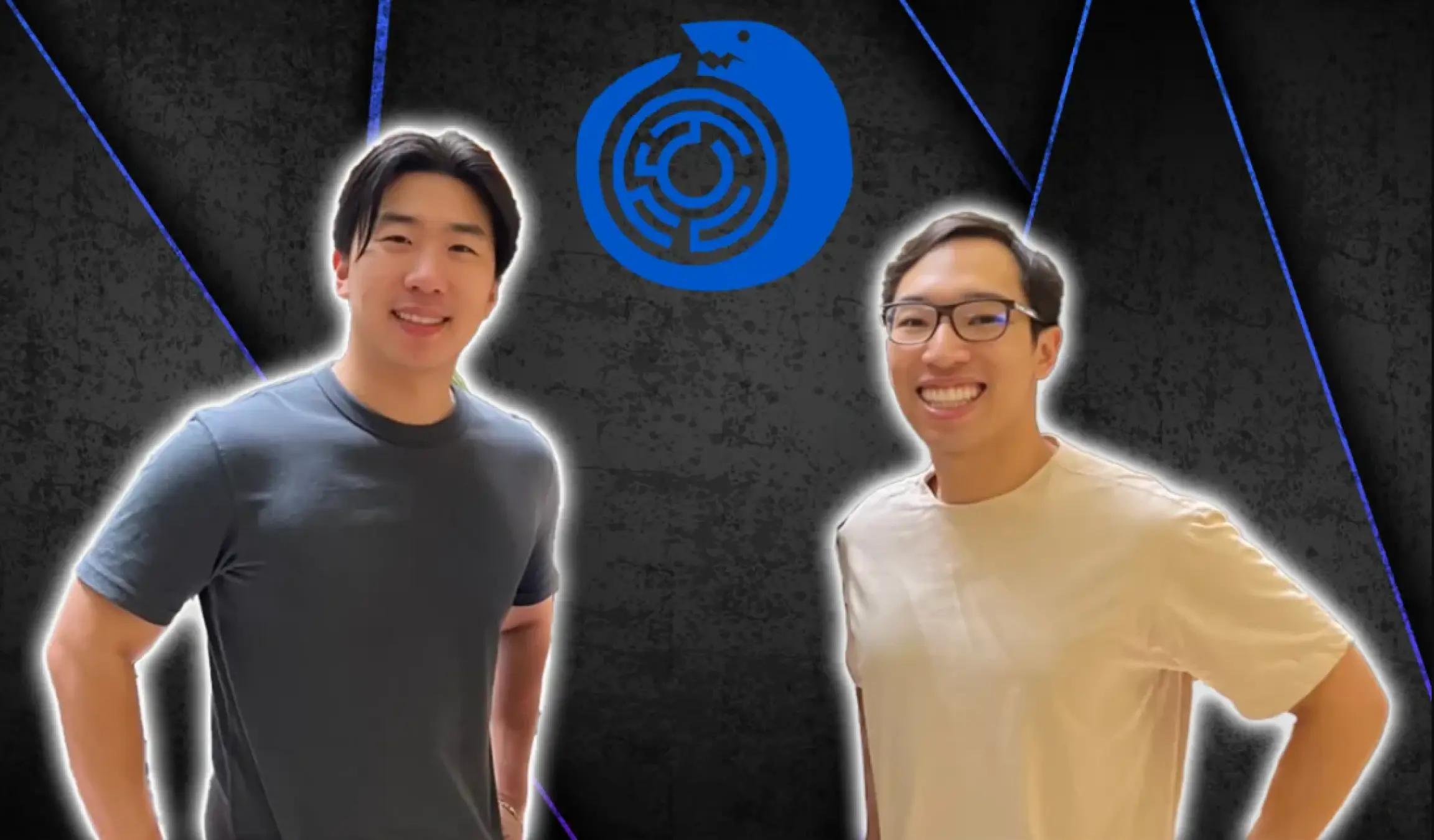 Robert Huynh and Oscar, CEO and CTO of Reforged Labs, smiling and posing in front of a vibrant anime-themed backdrop with colorful character illustrations at a convention or event.